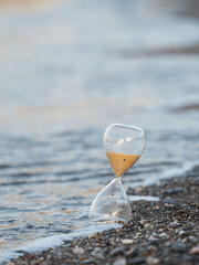 Hourglass on the beach at the seashore