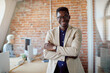 © Drazen - Portrait of confident black businessman at corporate office looking at camera.