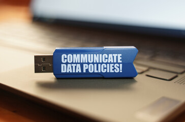 Poster - On the laptop keyboard is a flash drive with the inscription - COMMUNICATE DATA POLICIES