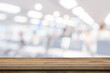 © tortoon - Empty wooden table anb Abstract blur airport interior for backgounrd