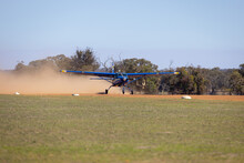 Small Plane Taxiing On Unsealed Dusty Runway In Rural Area