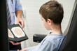 © Austockphoto - Young boy looking at optometrists book  for colour blind eye test