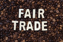 Fair trade word on roasted coffee beans background. Concept for cafe ,coffee shop ,business meeting ,office and drinking coffee beverage.