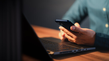 Poster - Closeup image of a man holding and using mobile phone or smartphone.