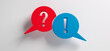 Red and blue speech bubbles with question and exclamation mark against white wall