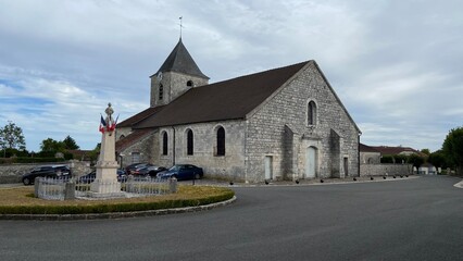 Wall Mural - Beautiful church an fountain in Colombey-les-Deux-église in France on August 2022