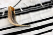 religion image of shofar (horn) on white prayer talit. Rosh hashanah (jewish New Year holiday), Shabbat and Yom kippur concept