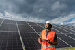 © Westend61 - Thoughtful engineer with tablet PC standing in front of solar panels