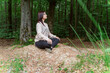 © Westend61 - Young woman practicing yoga in forest