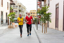 Senior Couple Running Around Town