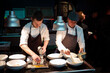 © ADDICTIVE STOCK - Cooks serving meal on restaurant kitchen