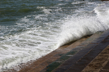 Wall Mural - a wave splashing on the sea steps