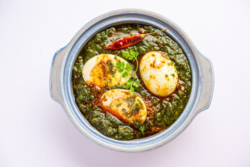 Spinach egg curry is an Indian non vegetarian dish made using palak gravy with eggs