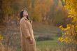 © Erika - woman in the autumn park. Woman nature. Forest. Fall. Fashion photo. Middle.