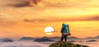 Man Hiker Standing on top of a mountain overlooking the landscape at sunset. adventure and travel concept.