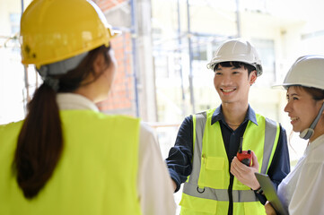 Wall Mural - Male civil engineer having a conversation with his construction inspector and architect