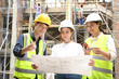 © bongkarn - Male civil engineer is explaining the building process to a female architect in the construction site.
