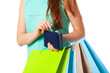 © Dmytro Panchenko - Closeup of womans hand with shopping bags opening wallet.