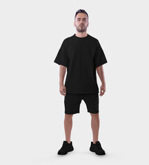 Wall Mural - Oversized black t-shirt template, shorts on a posing guy in sports sneakers, for design, pattern, advertising in an online store.