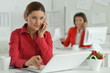 © aletia2011 - Businesswoman architect with smartphone in modern office with her colleague