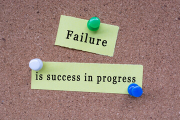 Wall Mural - Failure is success in progress words on stick note pinned to a cork notice board