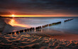 Morze bałtyckie. Plaża w miejscowości Chałupy - półwysep helski, piękny i kolorowy zachód słońca. Fale, piasek, wybrzeże, woda i falochron. Bałtyk