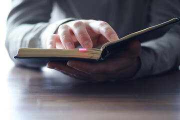 Wall Mural - Read book. A man sits and reads literature. Textbooks to study. Religion.