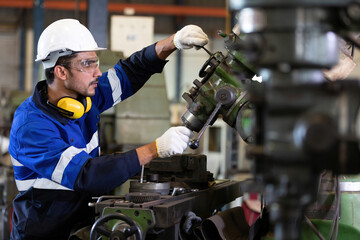 factory workers or technician checking and control lathe machine in factory