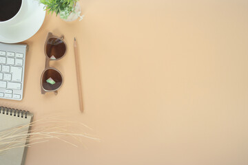 Fototapete - Flat lay of top view desk work table with Coffee computer notebook and pencil work space in minimal orange color autumn tone concept includes copyspace for add text or graphic