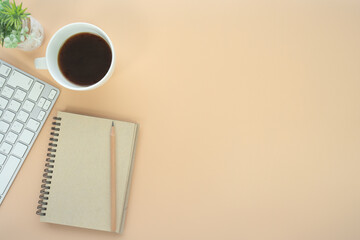 Fototapete - Flat lay of top view desk work table with Coffee computer notebook and pencil work space in minimal orange color autumn tone concept includes copyspace for add text or graphic