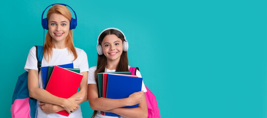 Poster - Mother and daughter child banner, copy space, isolated background. mother and daughter in earphones hold notebook and backpack ready to study, ebook.