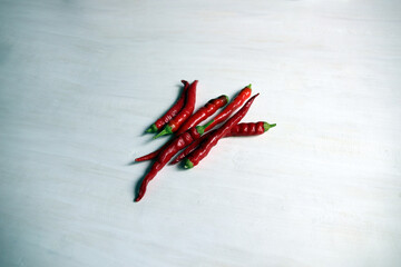 Wall Mural - red chili peppers on white wooden background