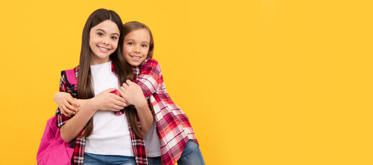 Sticker - School girls friends. concept of education. kids with long hair on yellow background. Banner of schoolgirl student. School child pupil portrait with copy space.