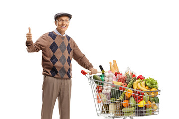 Poster - Elderly man standing with a shopping cart full of food and showing thumbs up