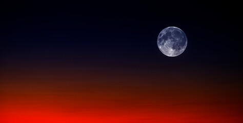 Sunset and Full Moon at Sunset or Sunrise on Horizon Orange and Blue Light