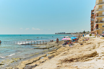 Poster - Lot of people sunbathing on the beach. Torrevieja, Spain