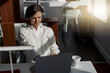 © Yaroslav Astakhov - Attractive european business woman working laptop while sitting in cozy cafe. Blurred background