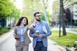 © Novak - Business couple walking in a park and discussing
