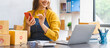 © Phushutter - Young excited asian SME woman working with parcel box and preparing product into the box.