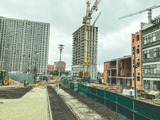 Wall Mural - construction of a new neighborhood in the city. erection of high, multi-storey buildings made of concrete, glass, blocks. construction of roads, communications