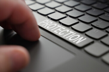 Poster - On the laptop keyboard of a person's hand, on the space bar there is an inscription - Protection