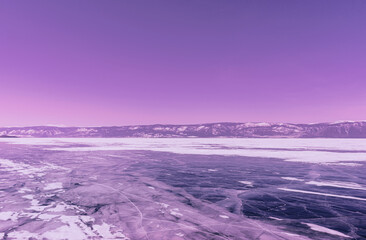 Wall Mural - Winter landscape with mountains and cracked ice of Baikal Lake in Siberia. Toned in trendy color. Natural background.