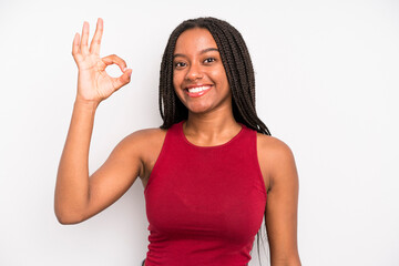 Wall Mural - black young adult woman feeling happy, relaxed and satisfied, showing approval with okay gesture, smiling