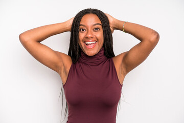 Wall Mural - black young adult woman looking happy, carefree, friendly and relaxed enjoying life and success, with a positive attitude