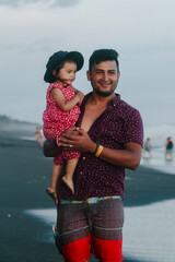 father and daughter admiring the sea with pastel tones and smile