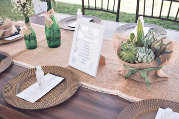 two green glass bottles decorated with ribbons and flowers on the table