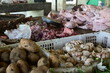 selective focus of meat infested by many flies in the traditional market. 