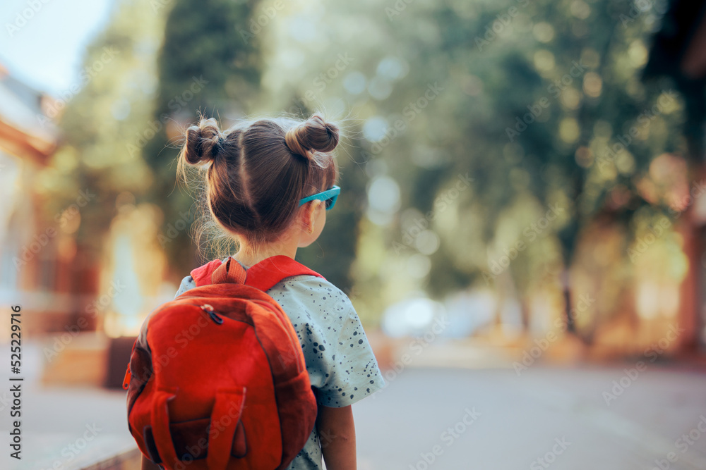 Portrait of a Little Girl Going Back to School . Child wearing a backpack ready for the first day of kindergarten

