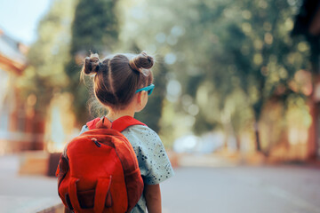 portrait of a little girl going back to school . child wearing a backpack ready for the first day of