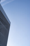 Fototapeta  - Corner of a modern steel building with geometric surface